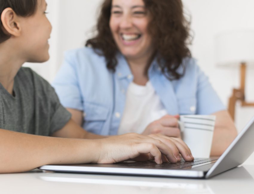 mother-with-child-working-laptop